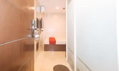 a hallway with a door to a room with a bed at RedDoorz at Regina Hometel J Victor in Manila