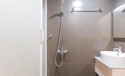 a bathroom with a shower and a sink at RedDoorz at Regina Hometel J Victor in Manila