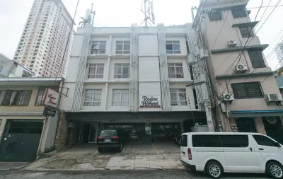 a white van parked in front of a building at RedDoorz at Regina Hometel J Victor in Manila