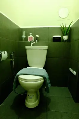 a bathroom with a toilet with a blue towel on it at Condotel in Manila