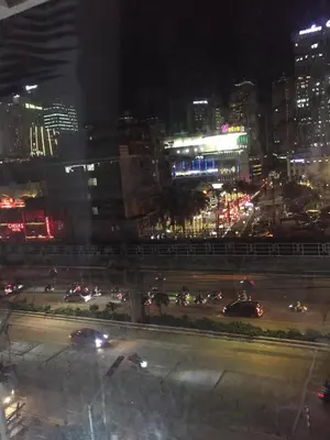 a view of a city at night with cars at Condotel in Manila
