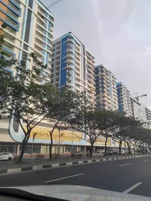 a city street with tall buildings and trees in front at Condotel by Heidi in Manila