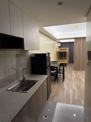 a kitchen with a sink and a kitchen with a table at Condotel by Heidi in Manila