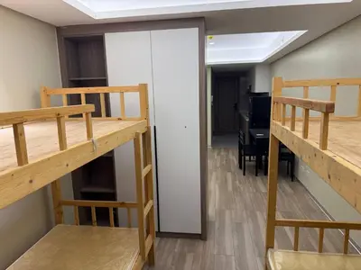 a room with two bunk beds and a dining room at Condotel by Heidi in Manila