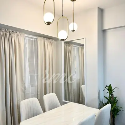 a dining room with a table and a mirror at A Space Close to Transits or Airport in Manila