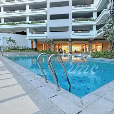 a swimming pool in front of a building at A Space Close to Transits or Airport in Manila