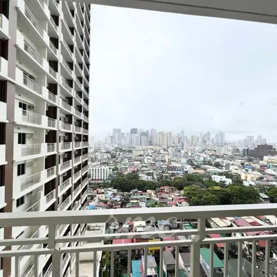 a view of a city from the balcony of a building at A Space Close to Transits or Airport in Manila
