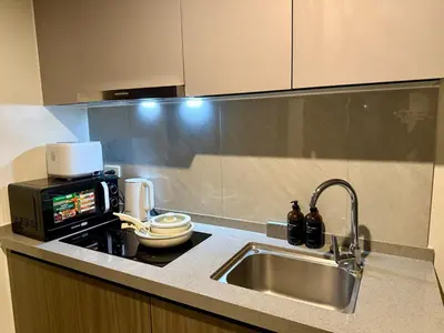 a kitchen counter with a sink and a microwave at pocco homestay in Manila