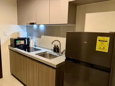 a kitchen with a sink and a microwave at pocco homestay in Manila