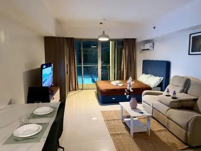 a living room with a couch and a bed at pocco homestay in Manila