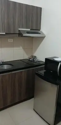 a kitchen with a microwave and a stove top oven at Solemare Parksuites - no balcony in Manila