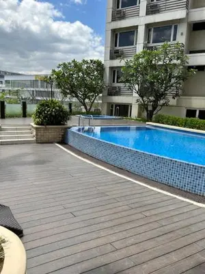 a swimming pool in front of a building at Solemare Parksuites - no balcony in Manila