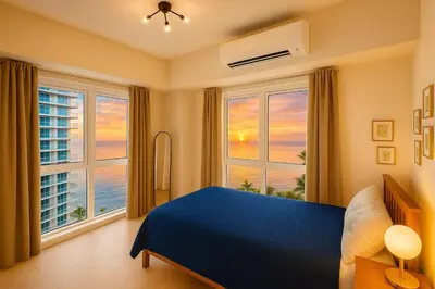 a bedroom with a blue bed and large windows at Luxury 1-Bedroom Apartment Across Okada Manila in Manila