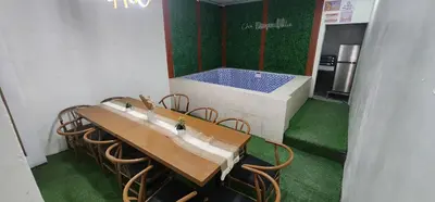 a room with a table and chairs and a tub at Cozy Villa with Pool for family or couples in Bacoor