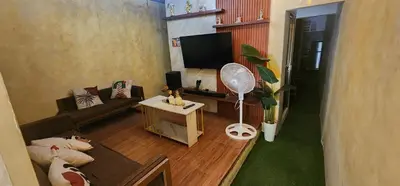 a living room with a couch and a fan at Cozy Villa with Pool for family or couples in Bacoor