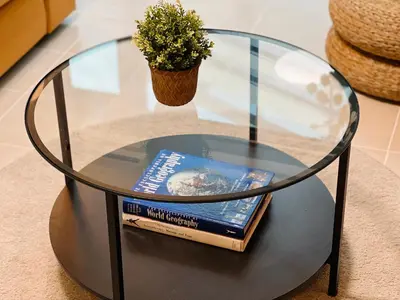 a book sitting on a glass table with a book at Spacious 1BR with 300MBPS Internet near High Street BGC in Manila