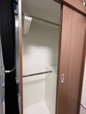 a walk in closet with a glass door at Marvinn's by LVH - 150 Newport Boulevard in Manila