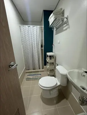 a bathroom with a toilet and a sink at Condo near SM City Sta Rosa unit 4 in Ibaba