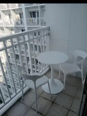a white table and chairs on a balcony at Sam's crib staycation in Manila