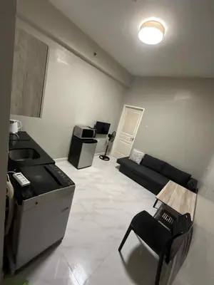 a large living room with a couch and a table at Condo Monarch Parksuites in Sampong