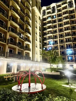 a red sculpture in front of a large apartment building at Condo Monarch Parksuites in Sampong