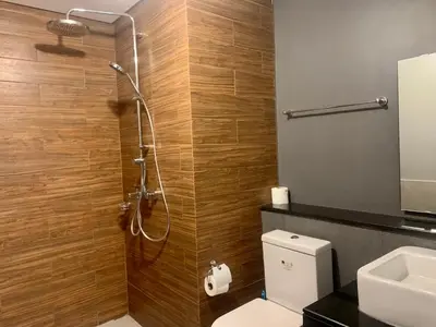 a bathroom with a shower with a toilet and a sink at Manila Bay Condo in Manila