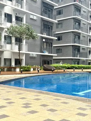 a swimming pool in front of a building at Soléa Suites in Manila