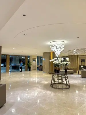 a lobby with a table with flowers on it at Soléa Suites in Manila