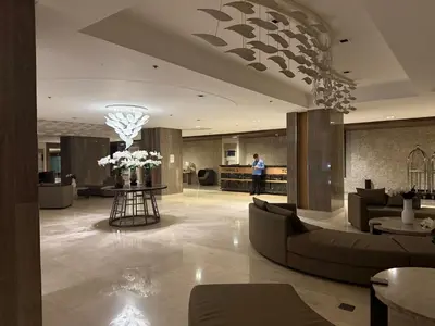 a man standing in a lobby of a hotel at Soléa Suites in Manila