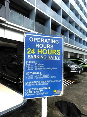 a parking sign in front of a parking garage at Soléa Suites in Manila