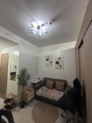 a living room with a bed and a ceiling fan at Amazing view in Shore 2 Residences by Richnells in Manila