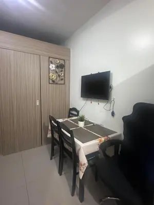 a dining room with a table and a tv on the wall at Amazing view in Shore 2 Residences by Richnells in Manila