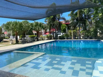 a large swimming pool with blue water at Norene Bianca Staycation in Carmona
