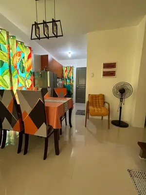a dining room with a table and chairs at Norene Bianca Staycation in Carmona