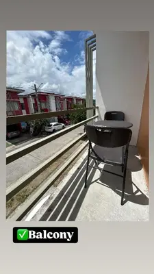 a desk on a balcony with a view of a building at Norene Bianca Staycation in Carmona