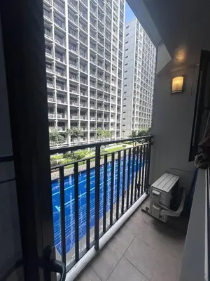 a room with a balcony with a view of a building at Shore 2 tower 1 by Richnells cozy Oasis in Manila