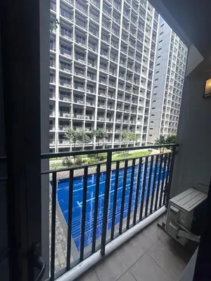 a balcony with a view of a large building at Shore 2 tower 1 by Richnells cozy Oasis in Manila