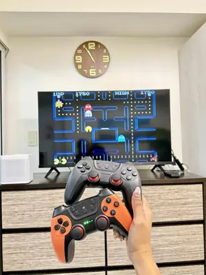 a person is holding a video game controller at Azure residences by Amóre Suites in Manila