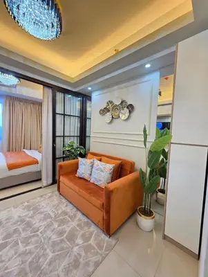 a living room with a couch and a bedroom at Jazz Haven Makati in Manila