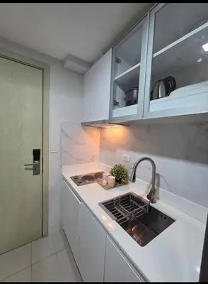 a kitchen with a sink and a counter top at Jazz Haven Makati in Manila