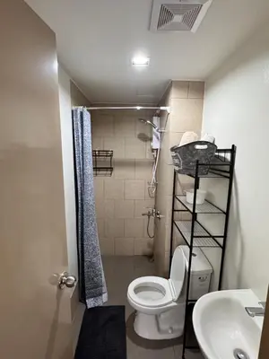 a small bathroom with a toilet and a sink at Mels Place at Tulip Garden Condominium Southwoods in Biñan
