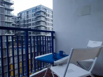 a balcony with a blue table and two chairs at My Cozy Little Crib - Sea Residence - Tower C in Manila
