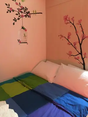 a bedroom with a bed with a bird cage on the wall at My Cozy Little Crib - Sea Residence - Tower C in Manila