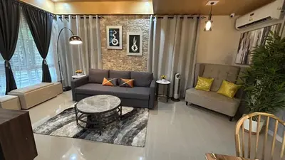 a living room with a couch and a table at The Grand Escape - Suntrust Verona, Silang Cavite in Silang
