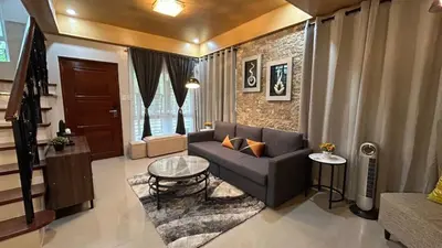 a living room with a couch and a table at The Grand Escape - Suntrust Verona, Silang Cavite in Silang
