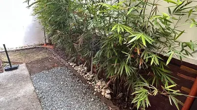 a fence with plants next to a building at The Grand Escape - Suntrust Verona, Silang Cavite in Silang