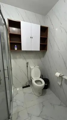 a white bathroom with a toilet and a shower at The Grand Escape - Suntrust Verona, Silang Cavite in Silang