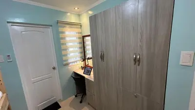 a bathroom with a large wooden cabinet in a room at The Grand Escape - Suntrust Verona, Silang Cavite in Silang
