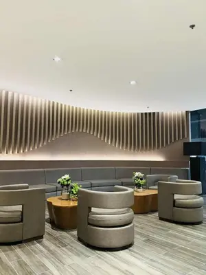 a waiting room with couches and tables and chairs at 3 single beds transient room mall of asia pasay in Manila
