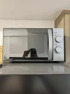 a microwave sitting on top of a counter at 3 single beds transient room mall of asia pasay in Manila
